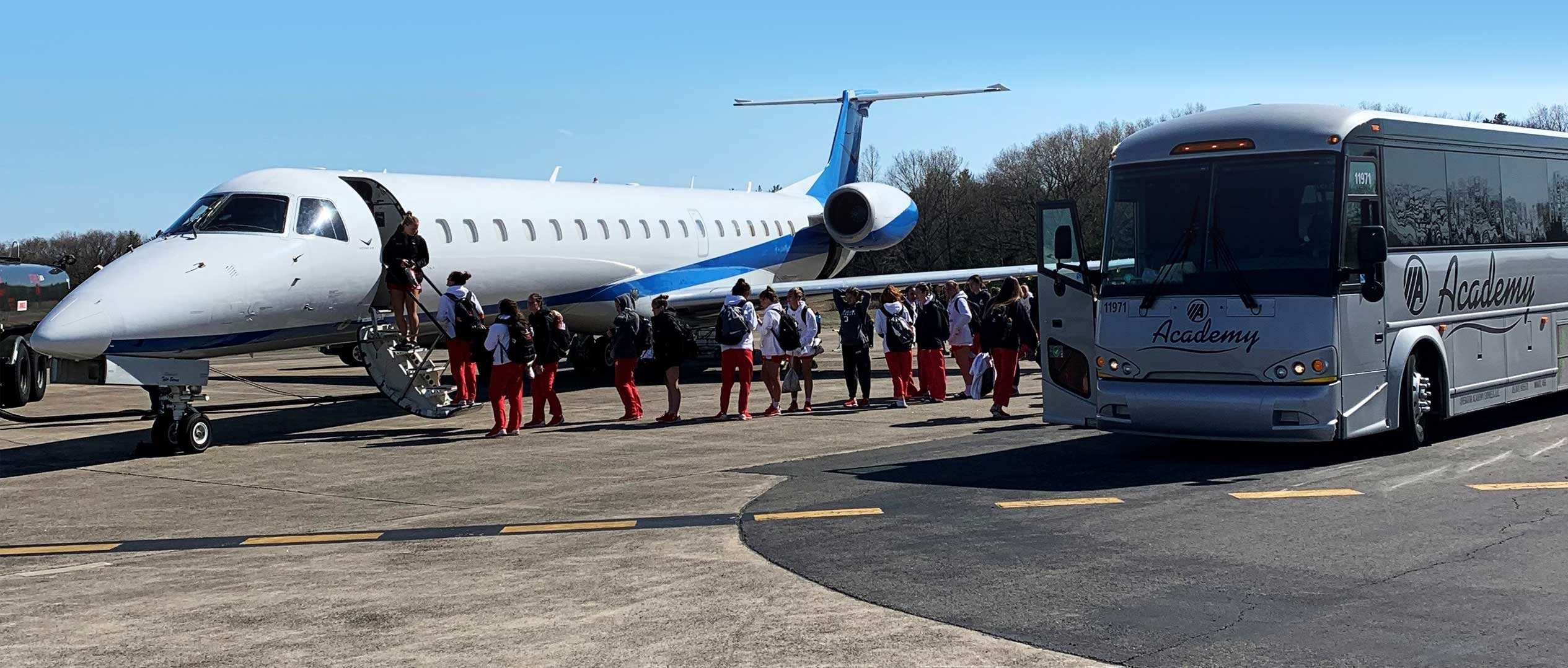 college basketball team boarding plane at westover airport
